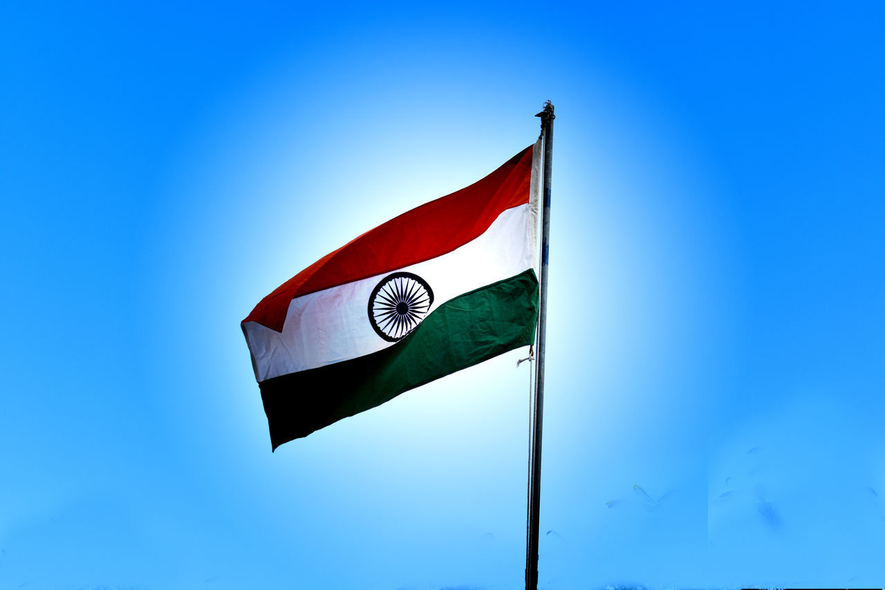 LOW ANGLE VIEW OF FLAGS FLAG AGAINST CLEAR BLUE SKY