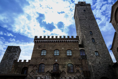 Low angle view of historical building against cloudy sky