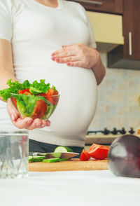 Midsection of woman preparing food on table