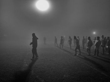 People walking on street at night