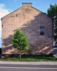 Road by building against sky