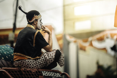 Midsection of woman playing guitar