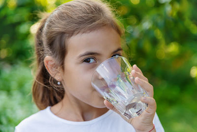 Girl drinking water outdoors