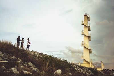 People standing on landscape against sky