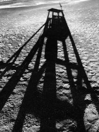 Shadow of person on sand at beach