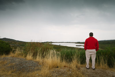 Rear view of woman standing on field