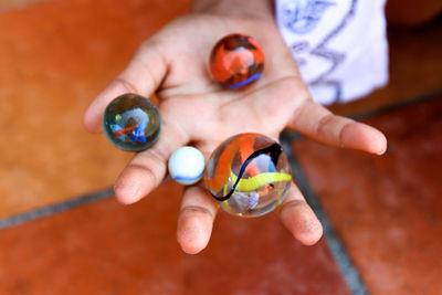 Cropped image of hand holding marbles