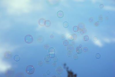 Close-up of bubbles against blue sky