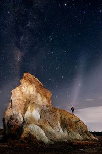 Scenic view of landscape against star field at night