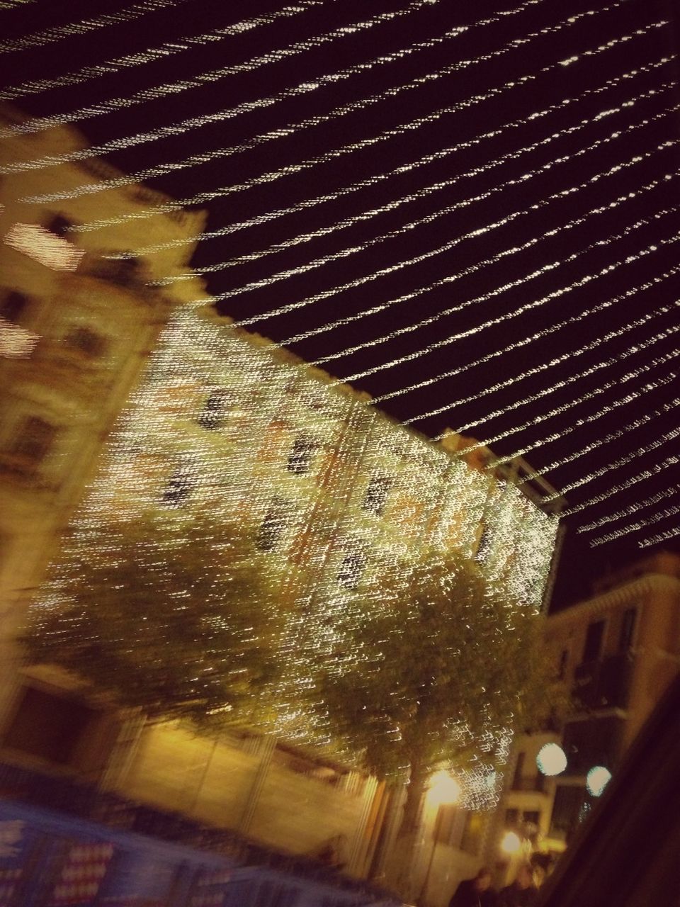 night, illuminated, architecture, built structure, building exterior, low angle view, indoors, building, reflection, pattern, wet, window, no people, lighting equipment, light - natural phenomenon, city, glass - material, dark, sky