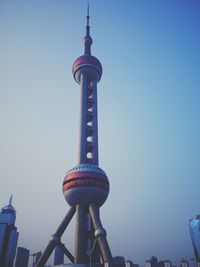 Low angle view of communications tower against sky