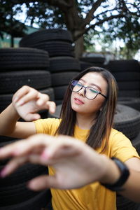 Portrait of smiling young woman holding eyeglasses