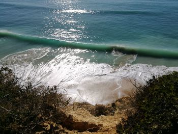 High angle view of waves splashing on shore