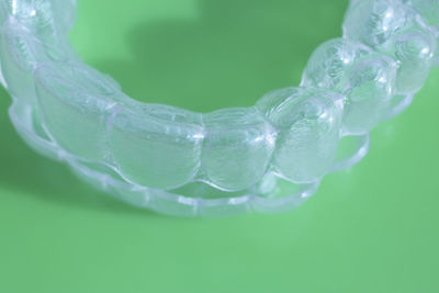 Close-up of artificial teeth over green background