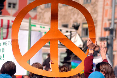People holding up a big peace sign at a really, peace movement on a demonstration