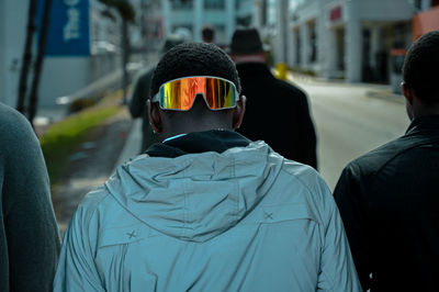 Rear view of man standing in city