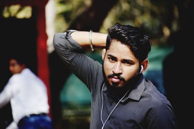 Portrait of young man with arms raised