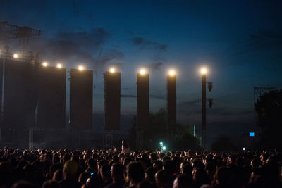 Crowd of people partying during a live rock concert at live music festival