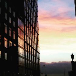 Low angle view of building against sky at sunset