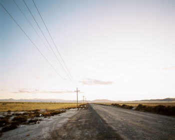 Country road against sky