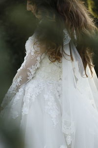 Midsection of bride standing outdoors