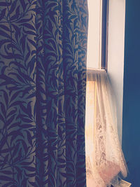 Close-up of curtain against window at home