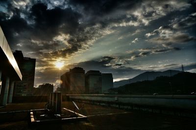Buildings against cloudy sky at sunset