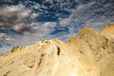 Low angle view of rock formations against sky