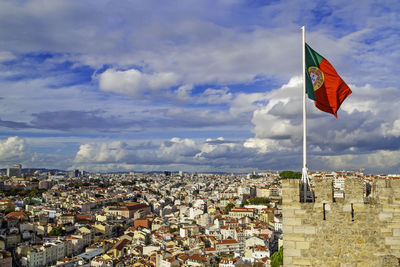 Low angle view of flag against buildings in city