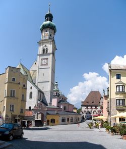 View of buildings in city against blue sky