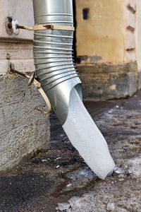 Low angle view of man working against wall