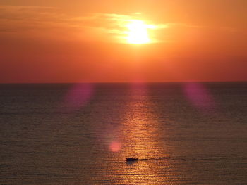 Scenic view of sea against romantic sky at sunset