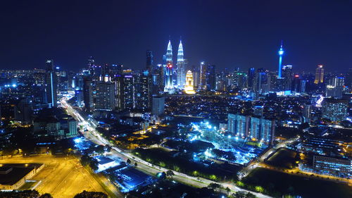 High angle view of city lit up at night