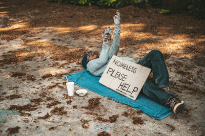 High angle view of man sitting on floor