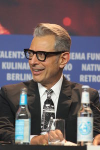 Portrait of mature man holding eyeglasses
