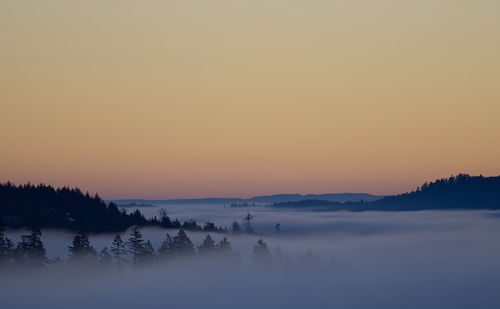 Scenic view of frozen lake against orange sky