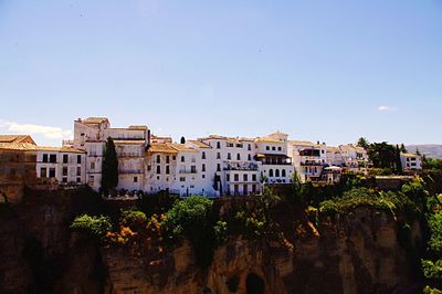 Buildings in city against blue sky