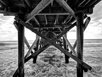 Below view of bridge over sea against sky