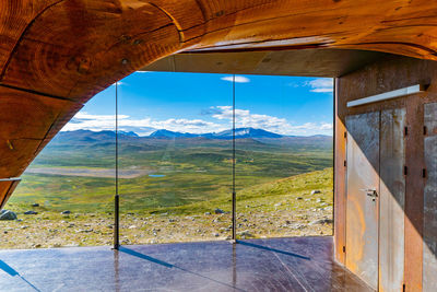 Scenic view of landscape seen through window