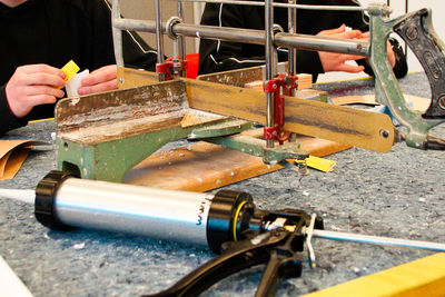 Close-up of person working on metal