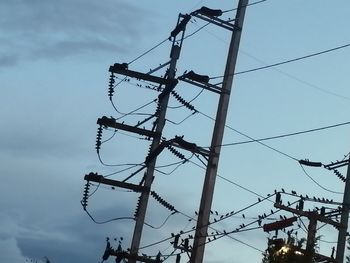 Low angle view of electricity pylon against sky