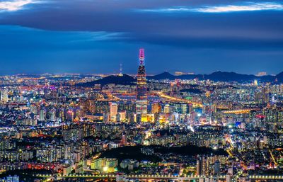 High angle view of city lit up at night