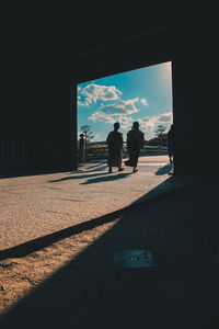 Rear view of silhouette people on window