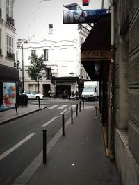 Road by city street against sky