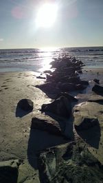 Close-up of sand on beach against sky during sunset