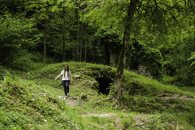 Rear view of man walking in forest