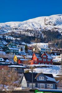 Houses in town against sky during winter