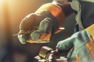 Cropped image of worker holding work tool