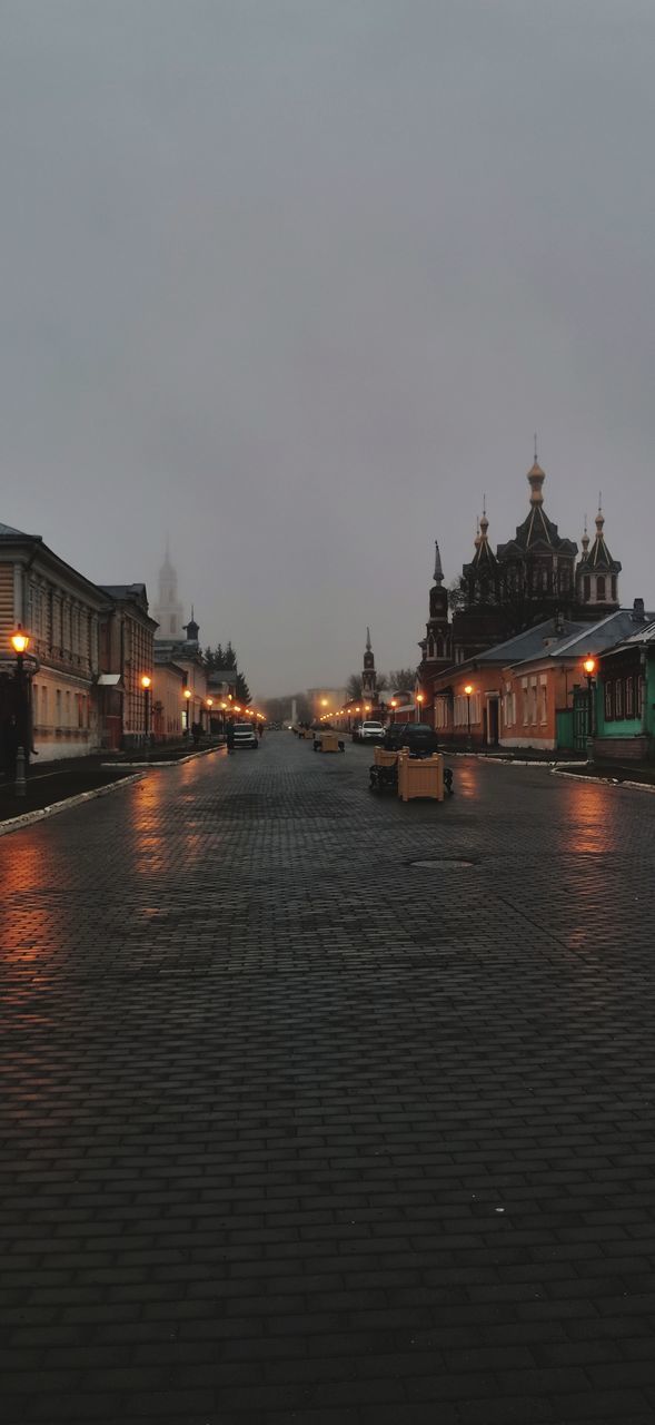 ILLUMINATED CITY BUILDINGS AT WATERFRONT