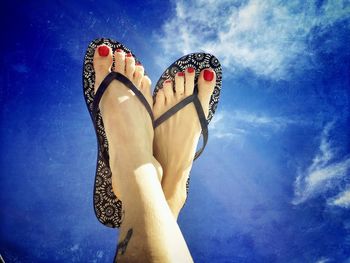 Low section of woman feet against sky